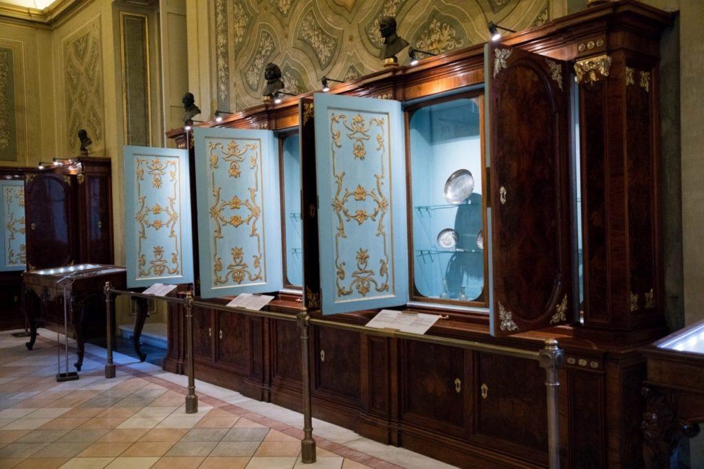 Blue and wood cabinets that hold the exhibits of the Vatican City Museum.