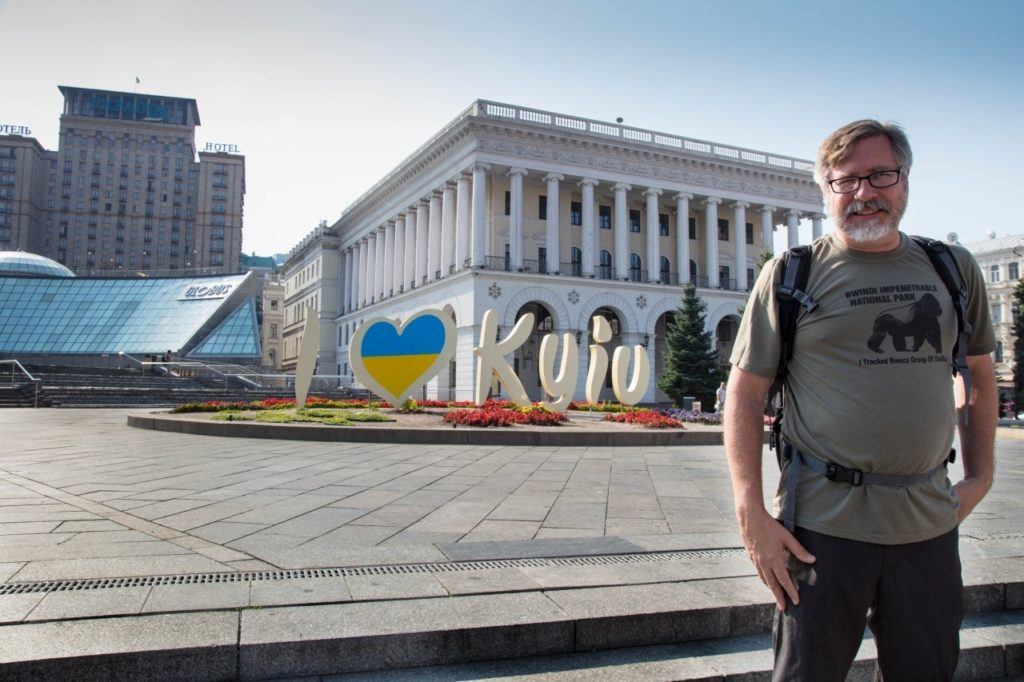Jim standing in front of I love Kyiv sign.