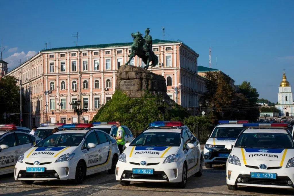 Police Cars in front of a statue in Kiev, Ukraine.