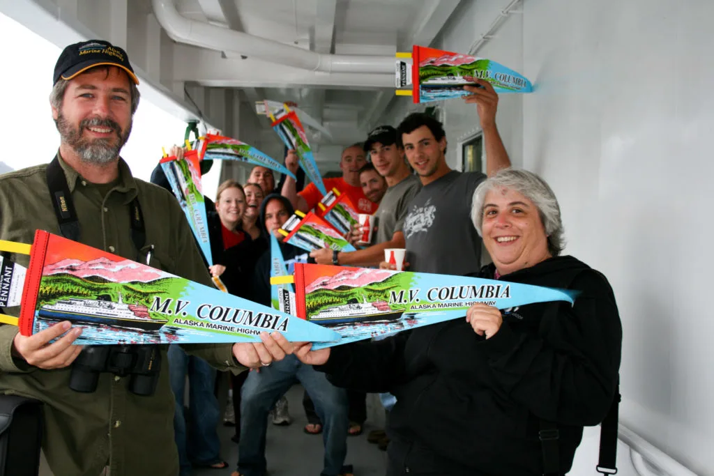 Passengers showing off their MV Columbia flags.