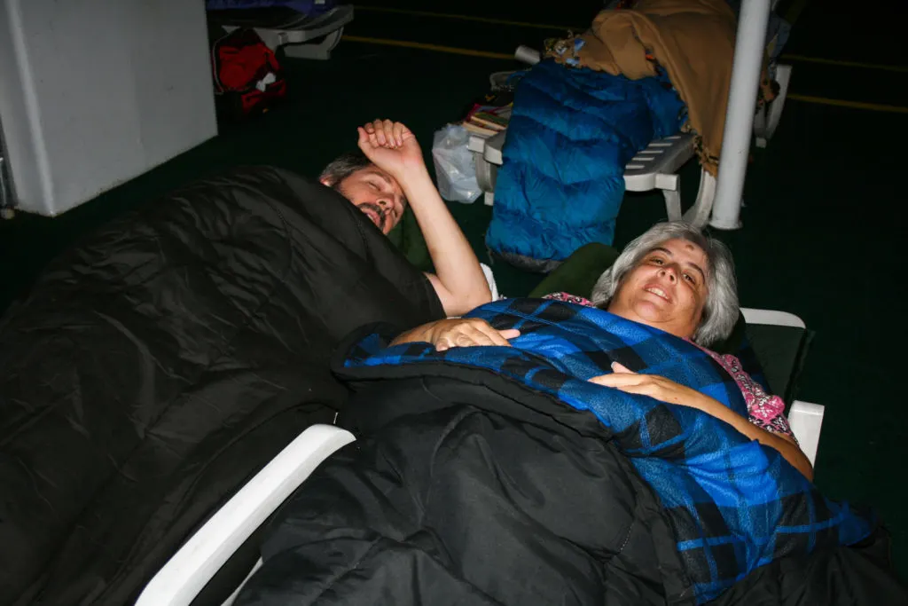 Jim and Corinne Vail sleeping on the solarium of the MV Columbia.