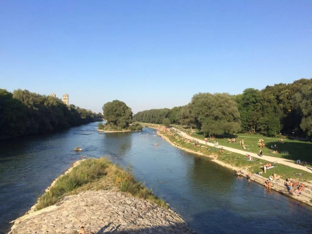 Summer bathers in the cool waters of the Isar river in Munich.