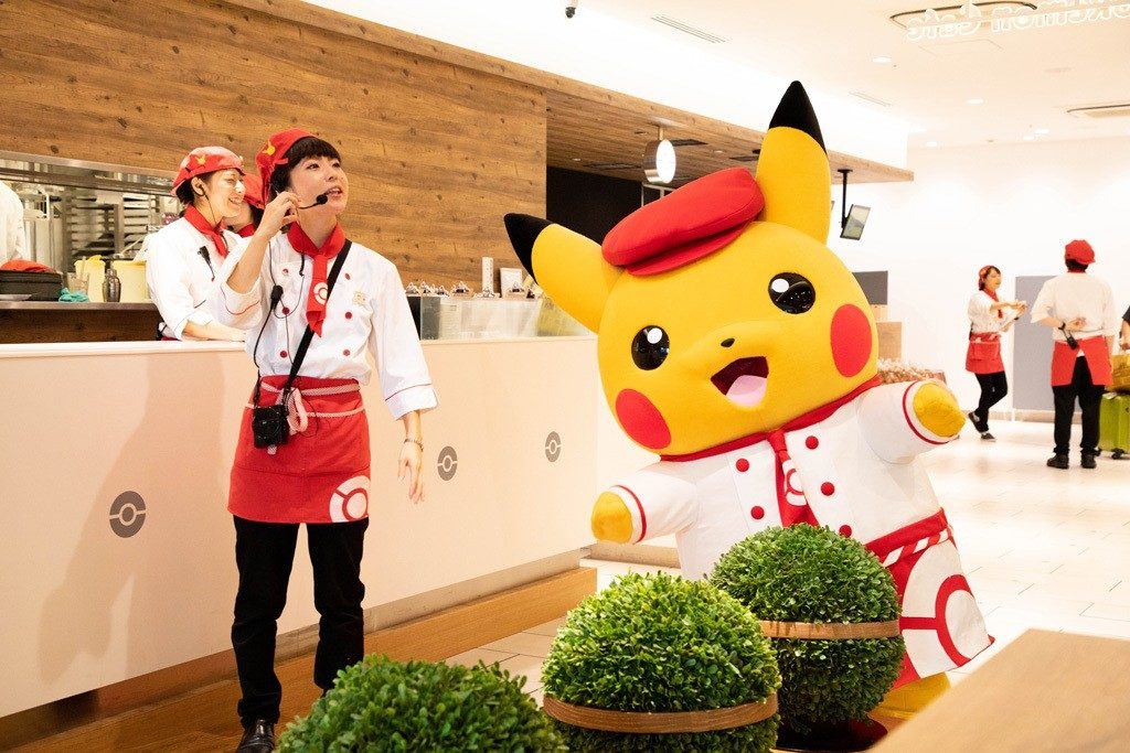 Pikachu and helper at the Pokemon Cafe.