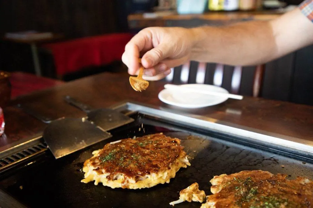 Cooking okonomiyaki right at the table in Sometaro, one of our favorite restaurants in Kamakura.