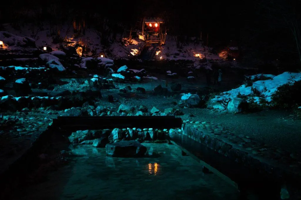 This park is illuminated in colored lights at night. There are many small hot spring pools along the paths, like this one.