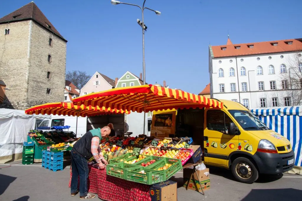 Produce Vendor sets up to sell at the Regensburg weekly market.