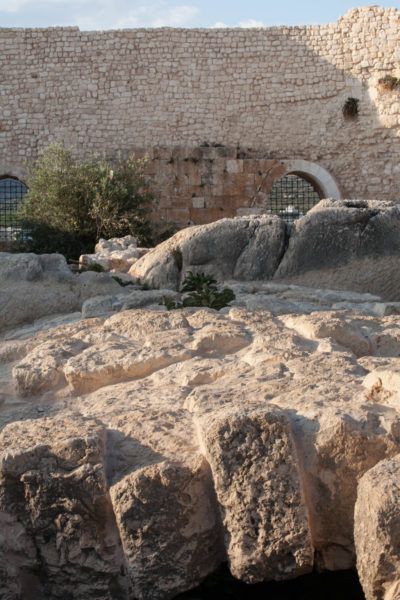 The ancient olive press stones and castle walls.