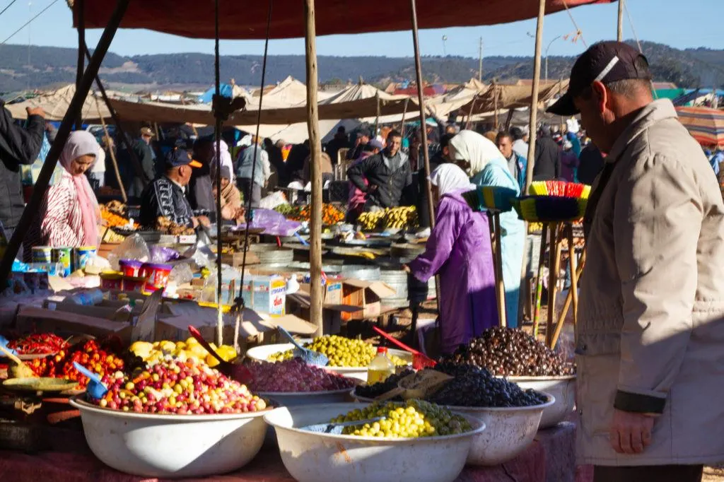 Stall at the Berber market with huge bowls heaped with different types and colors of olives.
