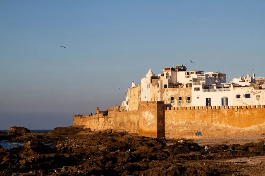A golden glow highlights the walls and white stucco houses of Essaouira.