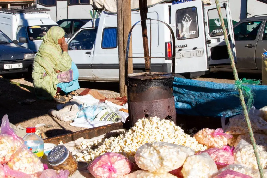 A vendor sells bags of popcorn on the road leading to the Berber Market in Azrou, Morocco.