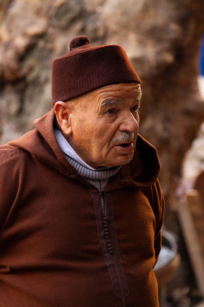 A Moroccan man in traditional dress, a djellaba and knit hat.