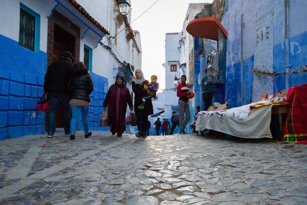Late afternoon shoppers walking through the Old Town of Chefchaouen.