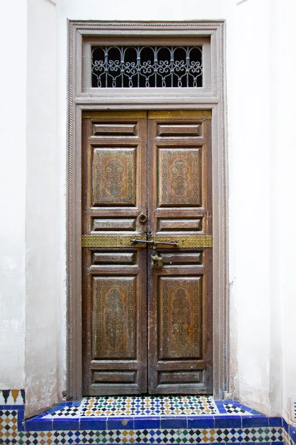 Door with decorative panels inside Bahia Palace Marrakesh Morocco.