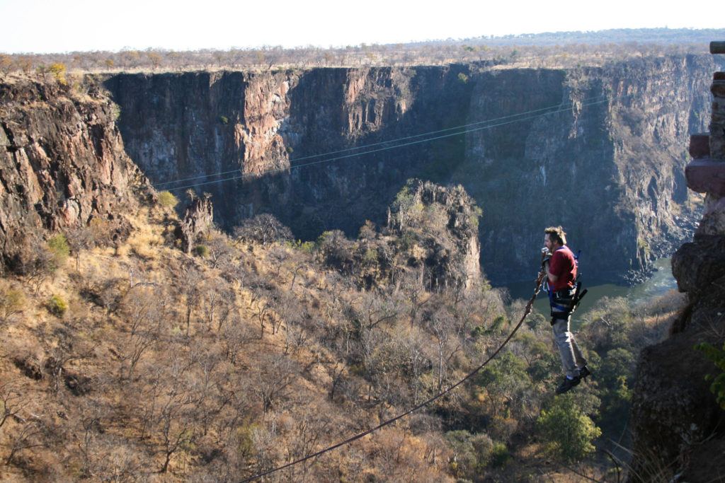 Jim jumping off the edge of Batoka Gorge on a rope swing.
