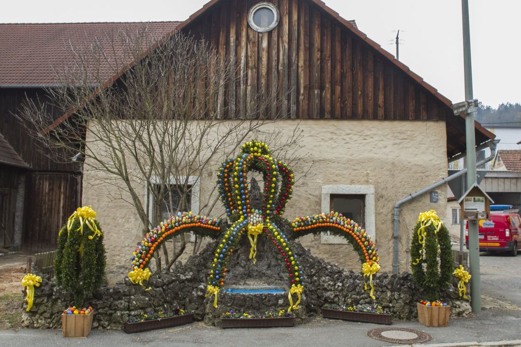 Easter eggs, pine boughs, yellow ribbons adorn this town fountain in Franconia.