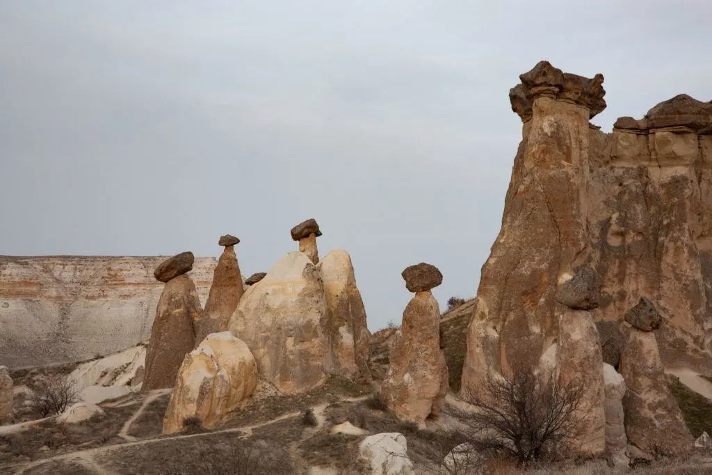 A cluster of fairy chimneys near Urgup, which form when rock pillars erode unevenly leaving a capstone on top.