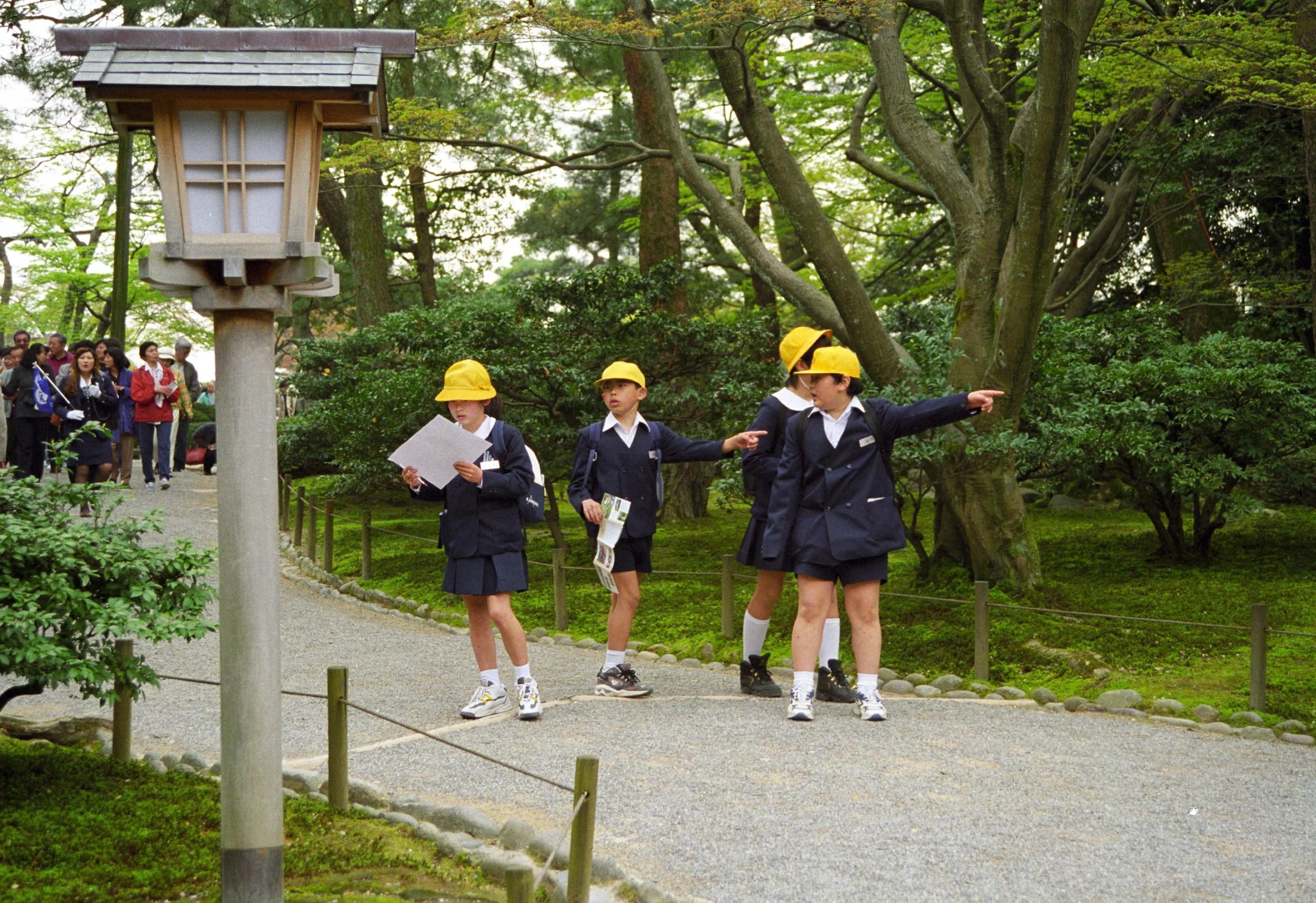 Japanese school children following a map.
