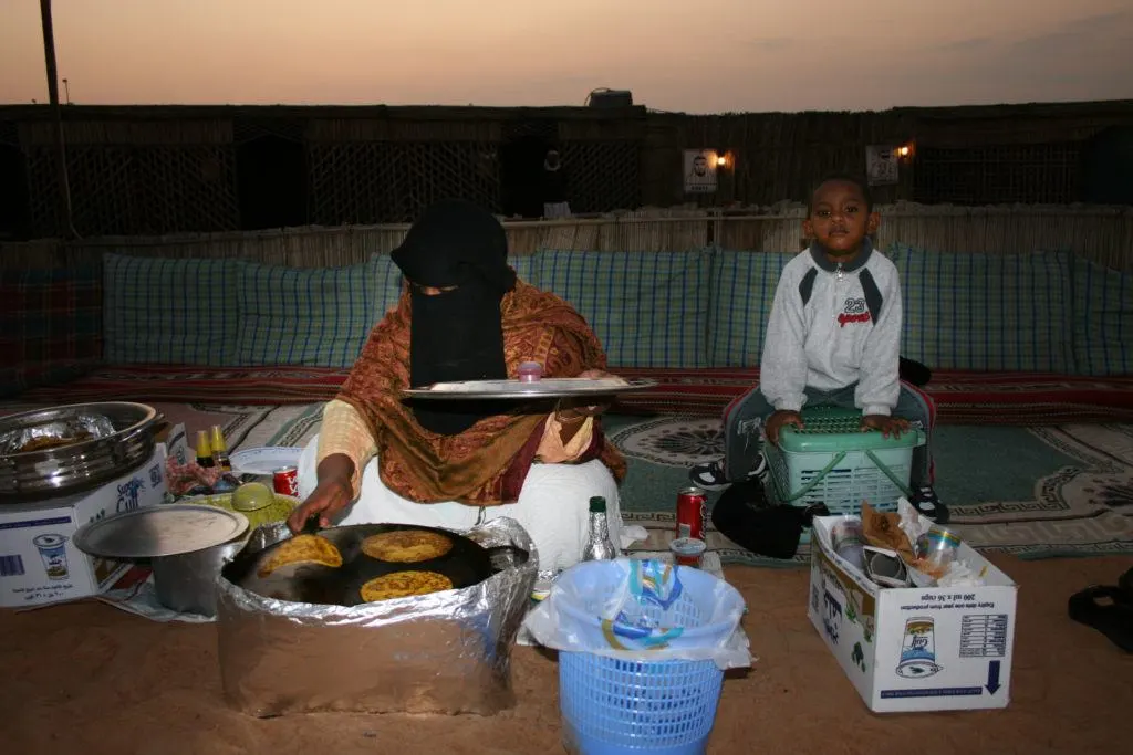 Trying homecooked flatbreads from this woman and her son at the Desert Night Tour.