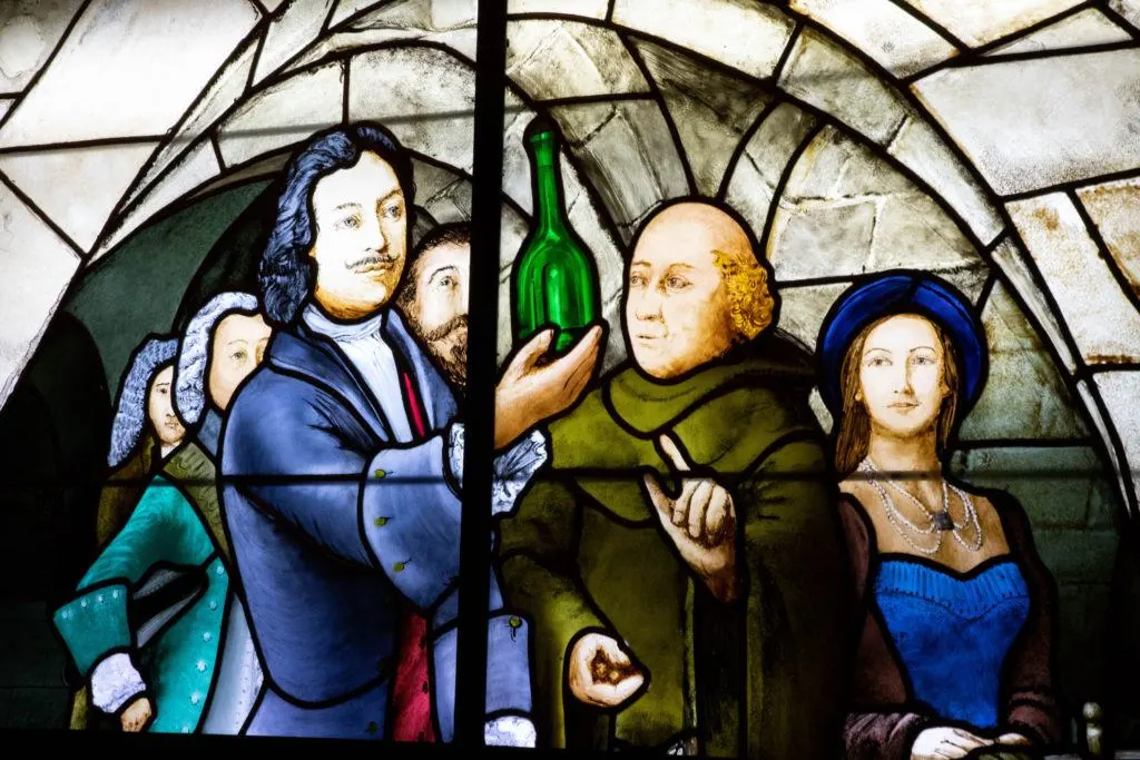 A stained glass window depicting the product of Champagne.