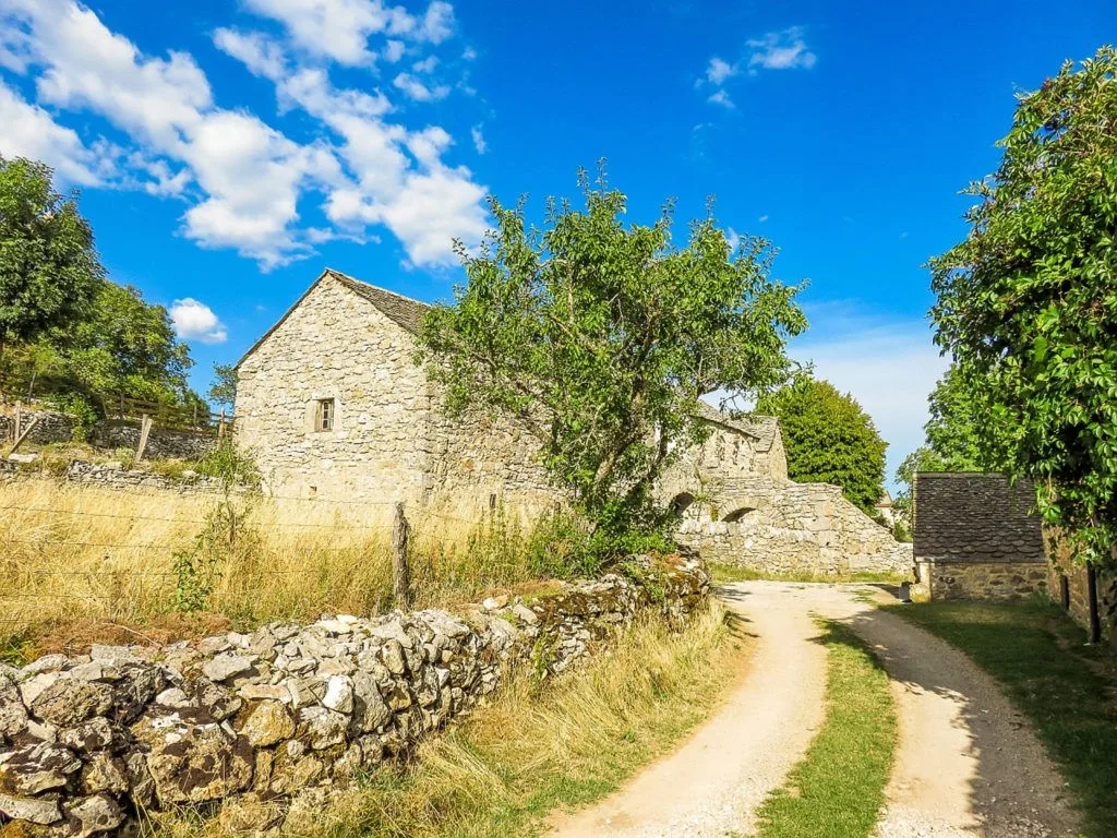 Stone house and dirt road in the Causses and Cevennes, France.