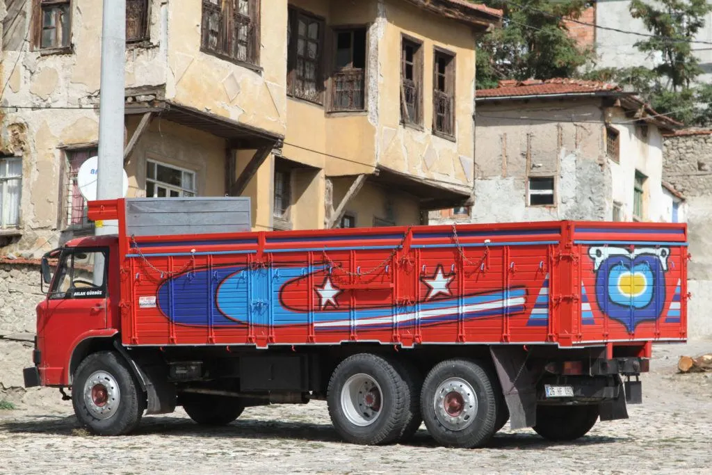 Red truck in Turkey painted with evil eye art.