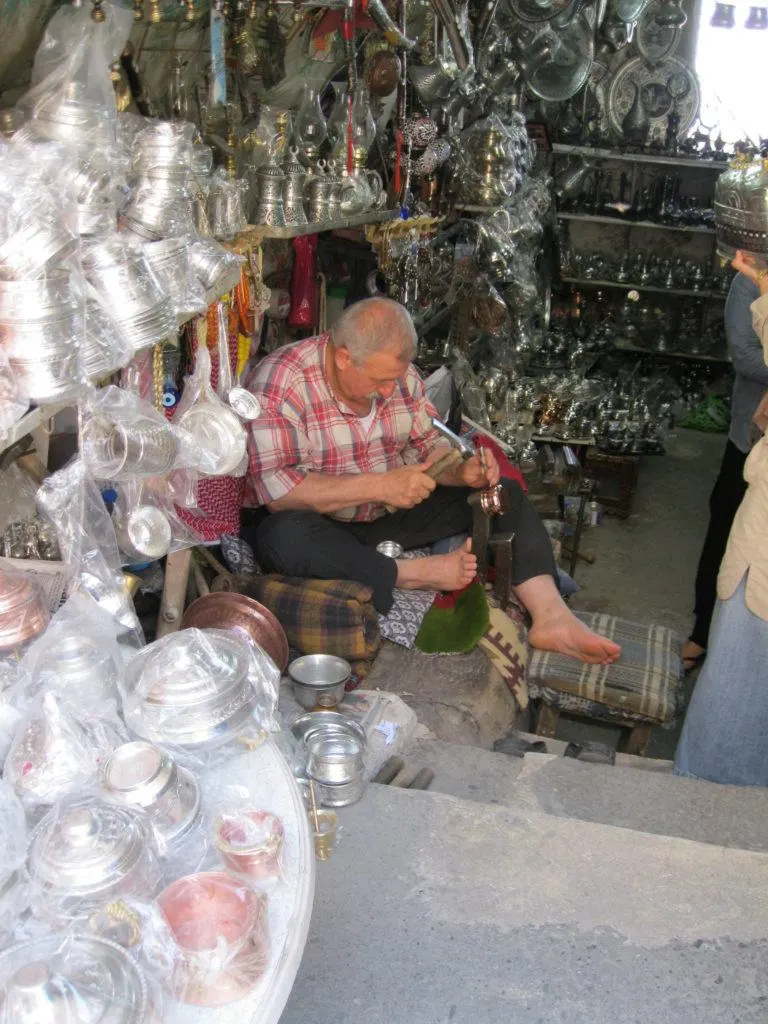 A copper artisan works in his shop in Gaziantep.