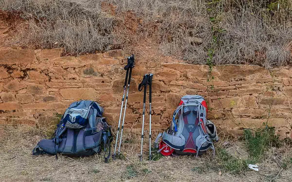 Backpacks and walking sticks used on the Camino de Santiago.