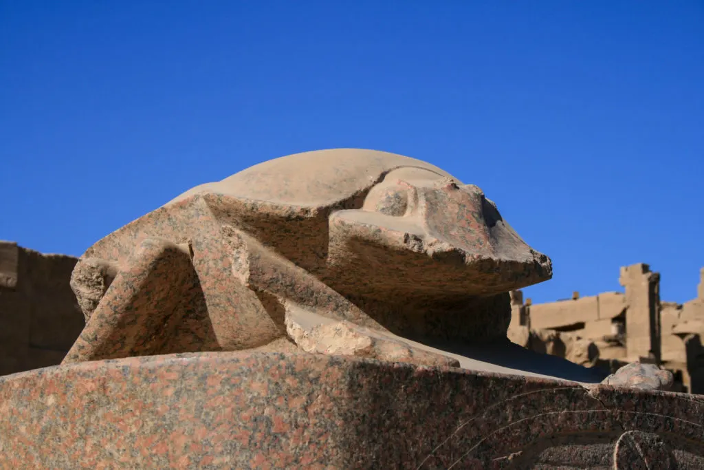A scarab sculpture at Karnak temple peeks over at you. Visiting the many temples in Egypt is a bucket list item.