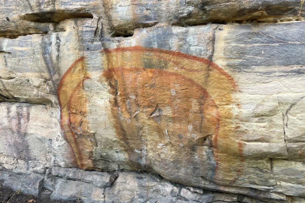 An Aboriginal art symbol for Rainbow Serpent painted on a rock wall at Ubirr rock art site.