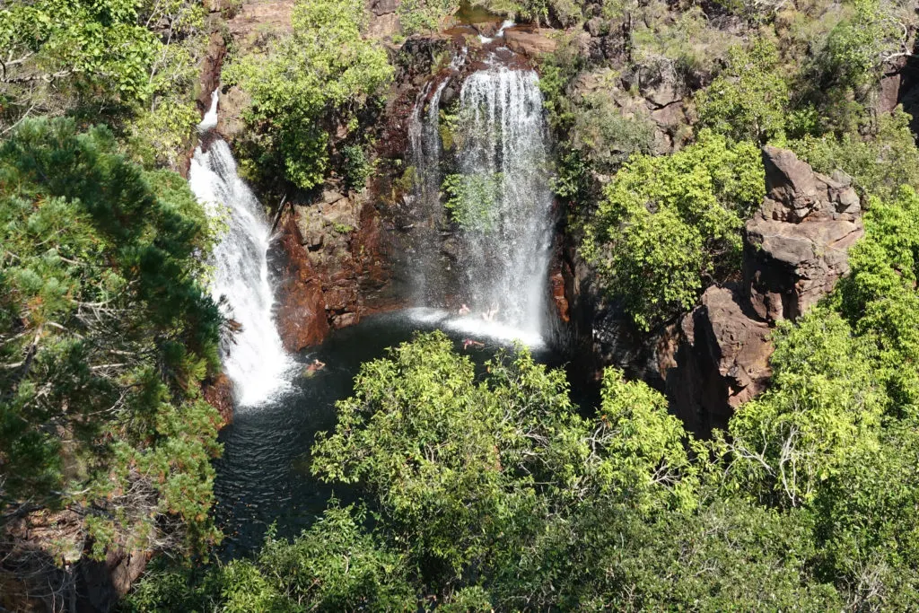 People swimming in the plunge pool at the base of Florence Falls in Litchfield National Park.