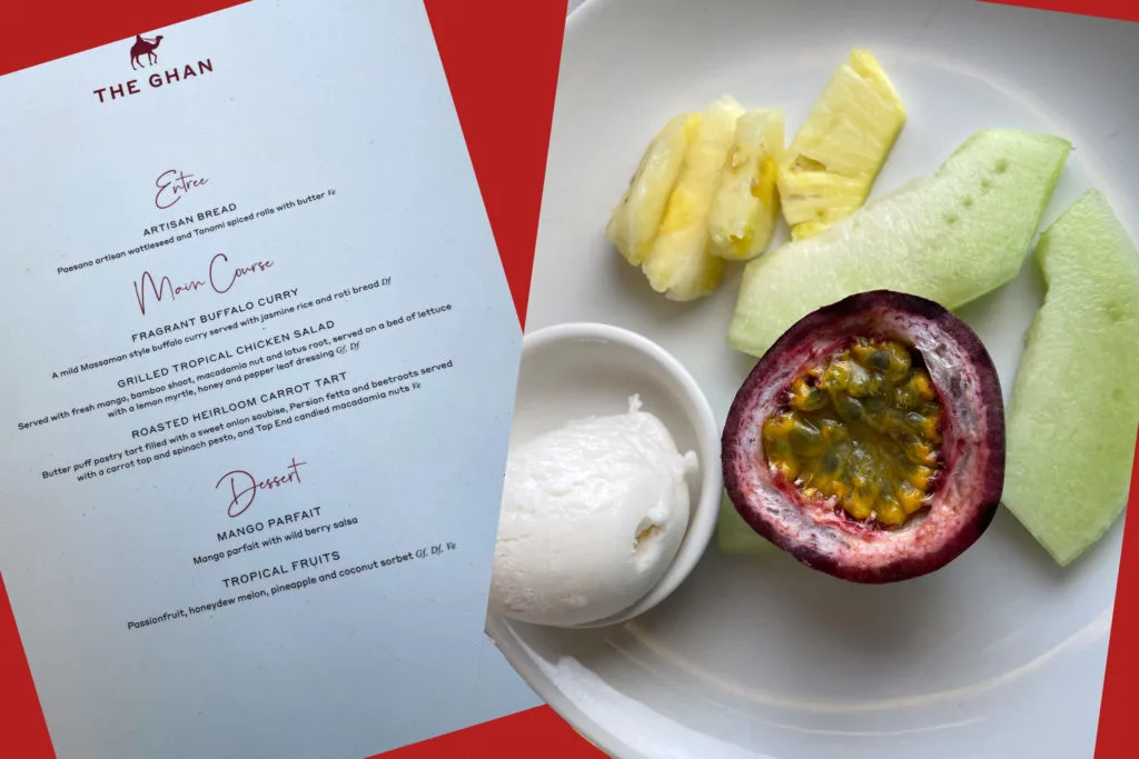 Lunch menu and plate of fruit in the Queen Adelaide Restaurant on The Ghan train.