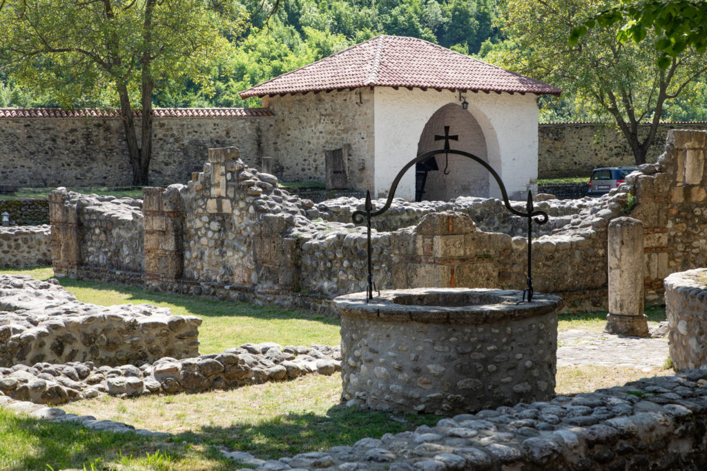 T well and ruins on the Pec Monastery grounds, Kosovo.