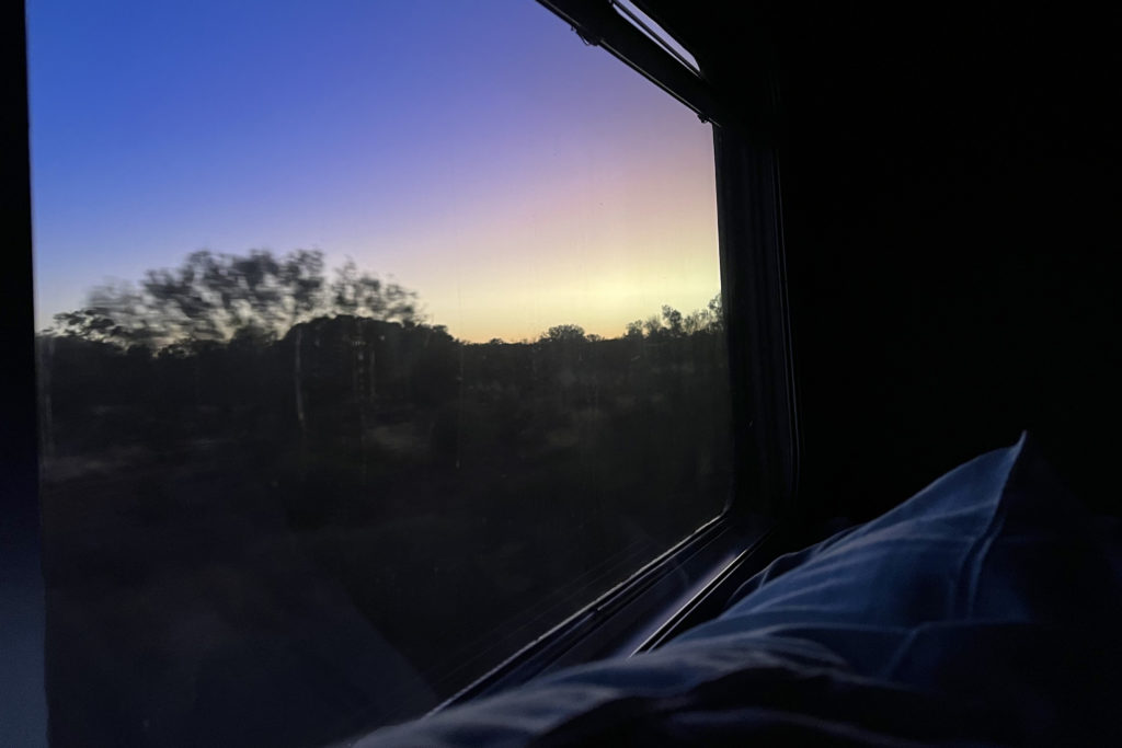 Watching the sunrise in Australia’s outback from bed in my Ghan train cabin.