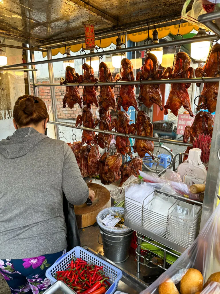Expats in Vietnam eat cheap, like buying a whole cooked duck from this vendor for only $15 US.