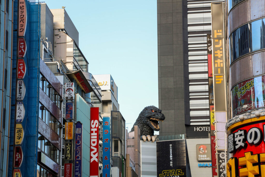 Godzilla peeks out of the tall buildings in the Akihabara neighborhood of Tokyo.