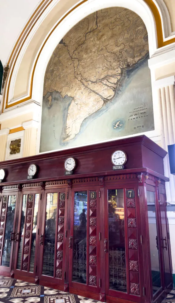 Interior of the Saigon Post Office showing a map and the telephone booths.