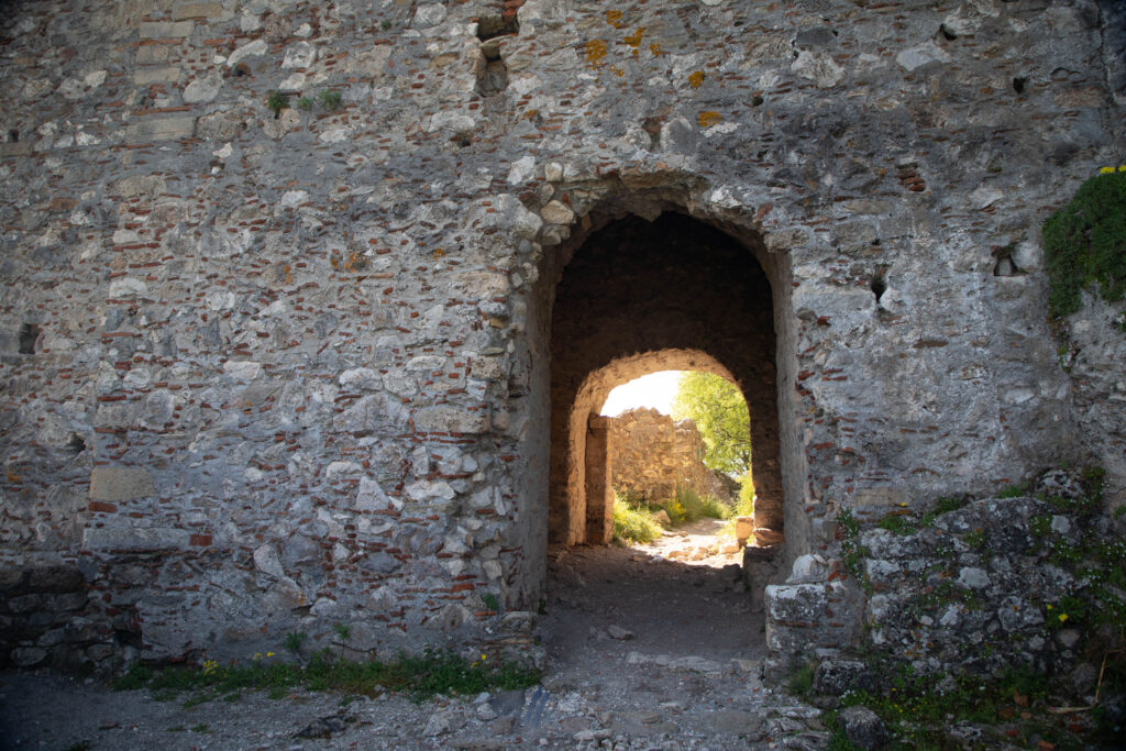 An archway beckons you into the Mystras Castle.