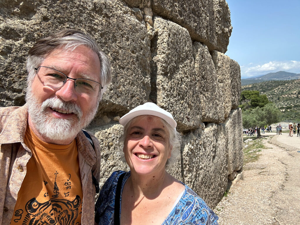 Jim and Corinne enjoy the huge boulders used to wall the Mycenaen city where Agamemnon once ruled.