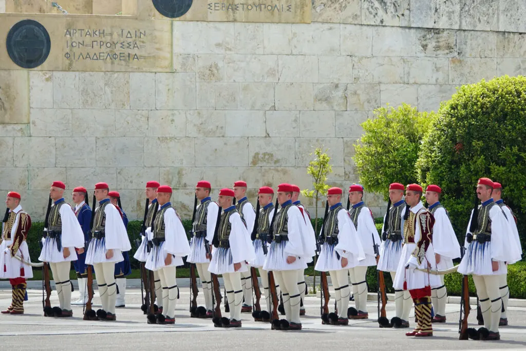 Guards, in their white ceremonial uniforms, at the Sunday morning changing of the guard ceremony in Athens Greece.