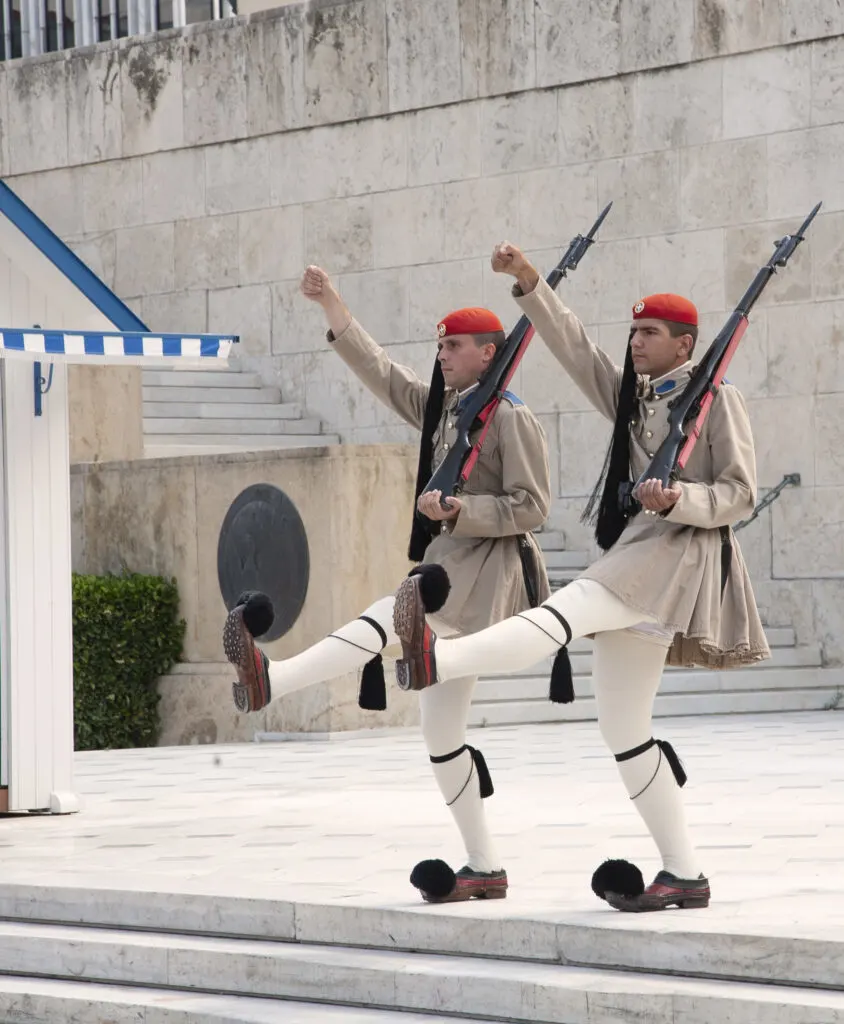 A pair of guards move in perfect unison at the guard changing ceremony in Athens Greece.