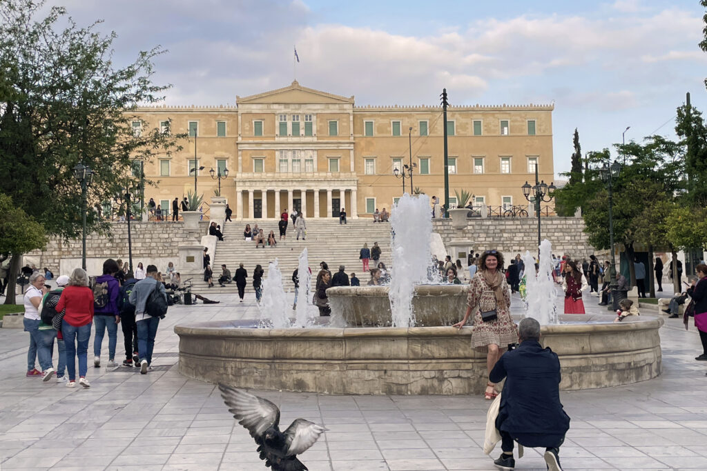 The fountain in Syntagma Square with Athens Parliament building in the background.
