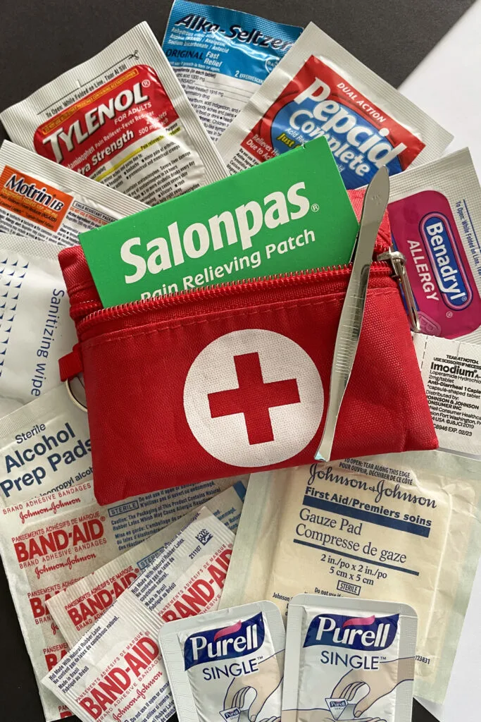 A tiny 3 x 4-inch first aid kit with basics like aspirin, Alka Seltzer, alcohol pads, and assorted band aids.