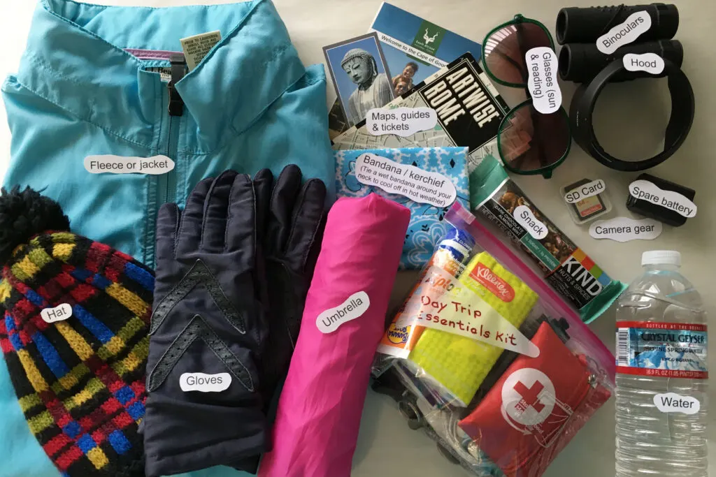 A display of all of the items listed on the one-day trip packing list that you might take depending on the weather.